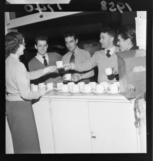 An unidentified women serving tea for a group of unidentified men, British Sailors' Society