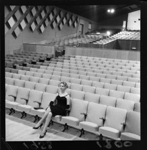 New Zealand actress Ngaire Porter sitting on a seat inside the new Regent Theatre, Naenae, Lower Hutt City, Wellington Region