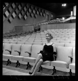 New Zealand actress Ngaire Porter sitting on a seat inside the new Regent Theatre, Naenae, Lower Hutt City, Wellington Region