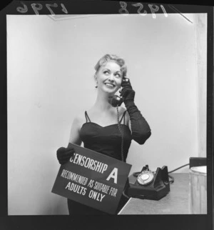 New Zealand actress Ngaire Porter holding a sign censorship, recommended as suitable for adults only at new Regent Theatre, Naenae, Lower Hutt City, Wellington Region