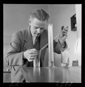 Mr R M Wulff measuring a glass of beer