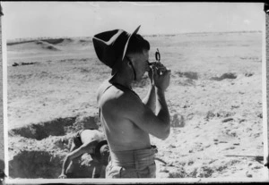 New Zealander taking bearings by prismatic compass during training