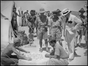 Prime Minister Peter Fraser watching Italian prisoners playing a board game, Helwan