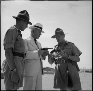 Prime Minister Peter Fraser handles a revolver at the NZ Infantry Training Depot, Maadi