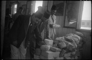 Egyptian customs officials examine parcels at Maadi camp, Egypt