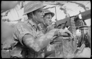 Soldiers operating machine gun