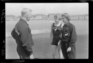 Two unidentified athletes and coach from New Zealand at the British Empire Games, Cardiff, United Kingdom