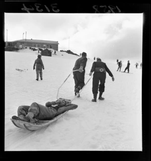 St John staff carrying an injured skier on a stretcher at the New Zealand Ski Championship, Mt Ruapehu