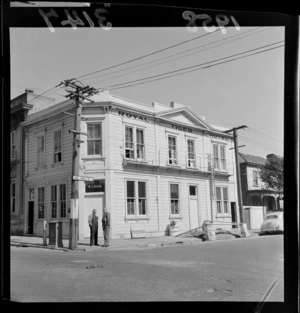 Exterior view of the Royal Tiger Hotel, Abel Smith Street, Te Aro, Wellington, including two unidentified men standing outside and talking