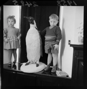 Unidentified Russian children standing with a stuffed penguin at the Russian Embassy, Wellington