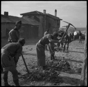 NZ infantrymen repairing road through a Greek village