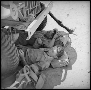 New Zealand soldiers resting under a vehicle, El Saff, Egypt