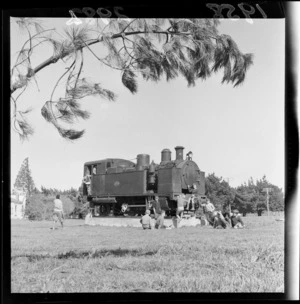 Unidentified boys sitting beside the Fell engine on a concrete block, Featherston