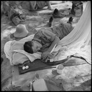 Soldier reading on a route march rest, Egypt
