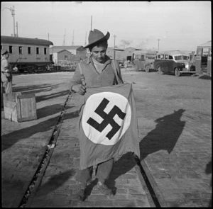 NZ sapper with captured Nazi paratroopers flag, Egypt
