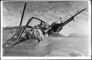 Navigator checking Vickers gun, Canada