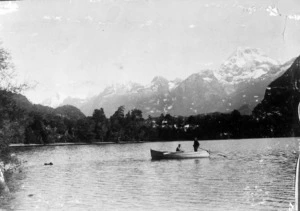 Hollyford River showing a row boat and mountains beyond