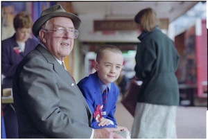 Bruce Cunningham and his grandson Sammy selling poppies on Poppy Day, Courtenay Place, Wellington - Photograph taken by John Nicholson