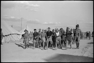 Italian prisoners marching back to POW cage after soccer match, Helwan