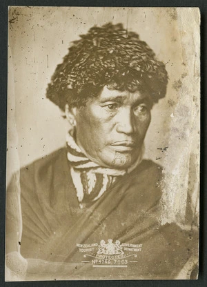 NZ Government Tourist Department : Portrait of unidentified Maori widow with moko kauae and wearing a potae taua