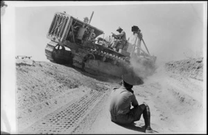 World War 2 New Zealand engineers preparing a tank trap in the Western Desert, North Africa, using a caterpillar tractor