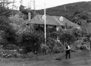 Henry Stevenson mowing the lawn at Pompallier House, Russell