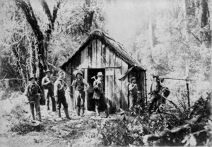 Men outside a hut at Milford Sound