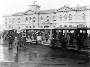 Three tram carriages, full with passengers, Cathedral Square, Christchurch