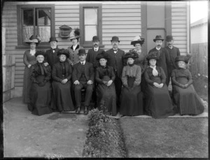Members of an unidentified family in front of the house, six men, nine women and a bird in a cage, probably Christchurch district