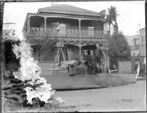Mock ship and unidentified crew, with a bulldog in front of a brick house, possibly Christchurch district