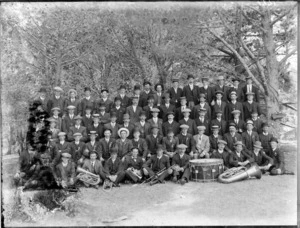 A group of unidentified people with brass instruments, in an unidentified park, probably Christchurch district