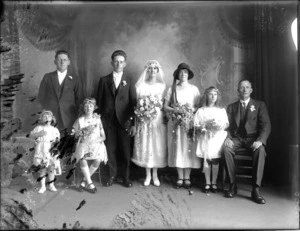 Studio wedding portrait of unidentified bride and groom, with wedding party and flowergirls, probably Christchurch district