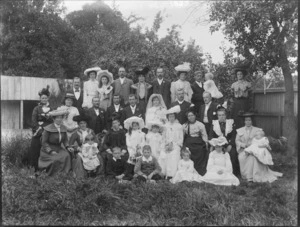 Unidentified wedding group outdoors, probably Christchurch district, showing bride and groom, wedding party and extended families