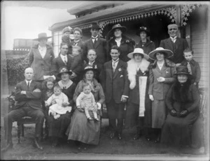 Unidentified family group outside a house, probably Christchurch district, includes small children