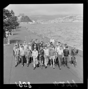 Unidentified anglers and underwater fishermen with rods and tackle, including spearguns, flippers, and snorkels, Oriental Bay walkway, Wellington