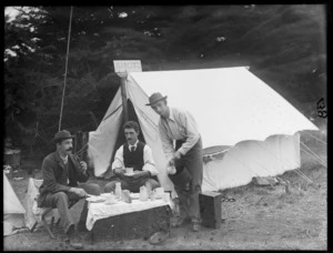 Group of unidentified men outside a tent having tea, possibly Sumner, Christchurch; sign on tent says 'Hyacinth'
