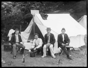 Group of unidentified men outside a tent with musical instruments, possibly Sumner, Christchurch; sign on tent says 'Hyacinth'