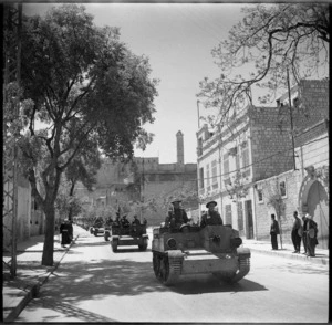Bren carriers passing along the streets of Aleppo with the Citadel in the background - Photograph taken by H Paton