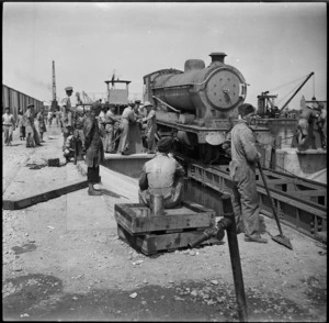 Uploading a locomotive from a lighter to the wharf at a Syrian port - Photograph taken by H Paton