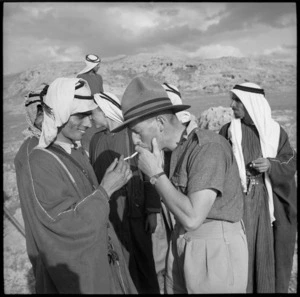 NZ soldier enjoys a smoke with an arab of Trans Jordania, World War II - Photograph taken by M D Elias