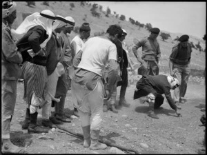 Long jump contest between members of NZ Divisional Cavalry and Syrian tribesmen, World War II - Photograph taken by H Paton