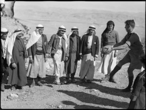 Member of NZ Divisional Cavalry demonstrates football to Syrian tribesmen, World War II - Photograph taken by H Paton