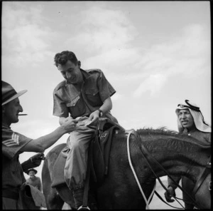 Winner receives dividend at race meeting held by 36 NZ Survey Bty in Trans Jordania, World War II - Photograph taken by M D Elias
