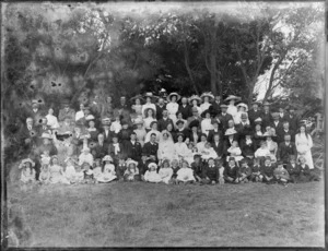 Large unidentified wedding group outdoors, showing bride and groom, groomsman, bridesmaid, flowergirls and extended families, probably Christchurch district