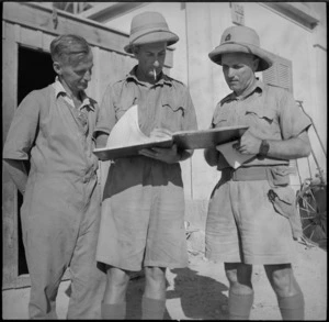 Officers of New Zealand Railway Operating Unit work out control schedules in the Western Desert, World War II