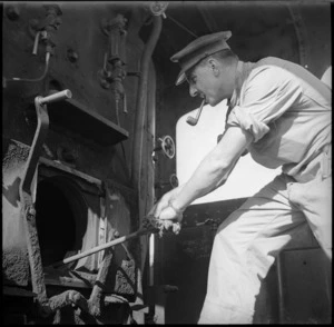 J Kelman stoking locomtive in the Western Desert, World War II