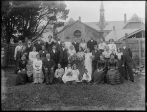 Unidentified wedding group outdoors, showing bride and groom, wedding party and extended families, probably Christchurch district