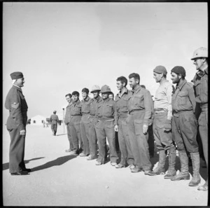 Officer directing former prisoners to hutments at NZ Base Camp, Egypt - Photograph taken by M D Elias
