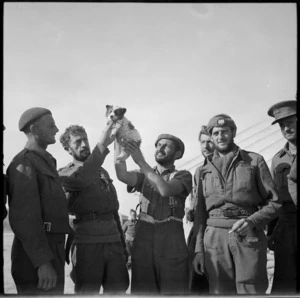 Returned prisoners holding up a dog at NZ Base Camp, Egypt - Photograph taken by M D Elias