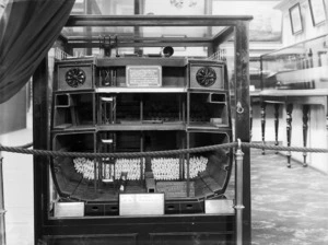 Looking inside the model of a ship displaying refrigerating machinery, at the New Zealand International Exhibition in Christchurch
